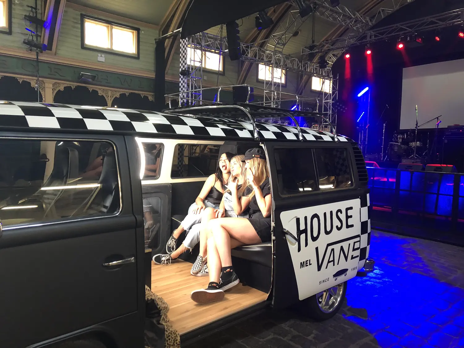 Three guests posing inside a House of Vans kombi van converted into a photo booth